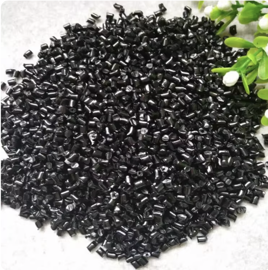 Black masterbatch pellets on a tray
